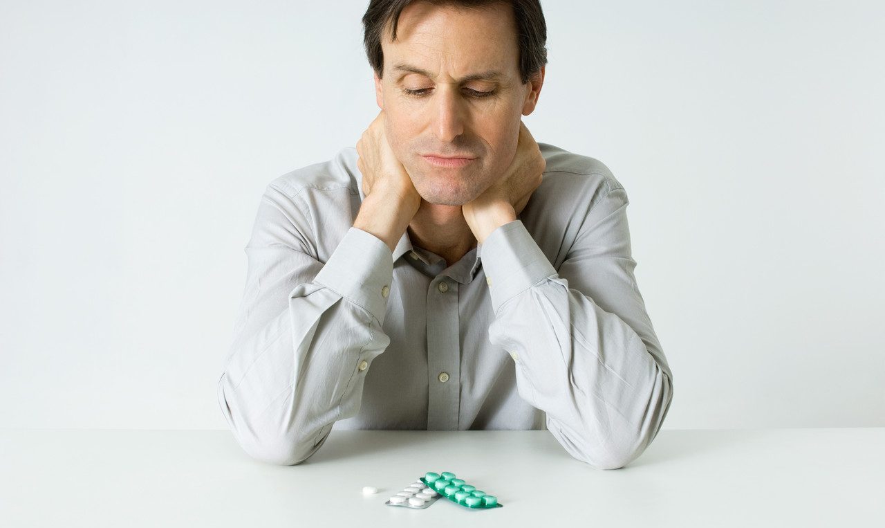 man looking at his medications