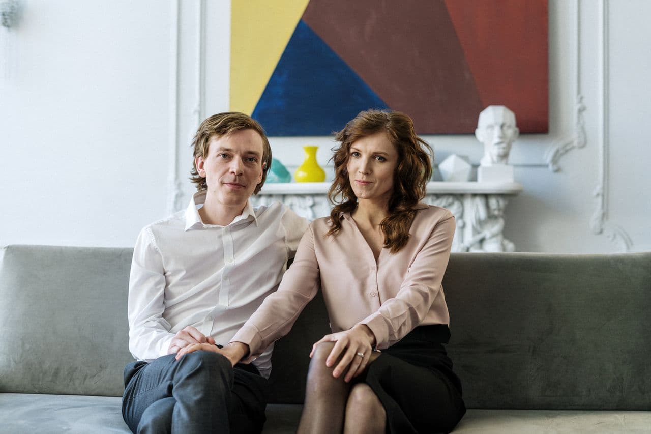 man-in-white-long-sleeve-shirt-sitting-beside-woman-in-white-long-sleeve-shirt